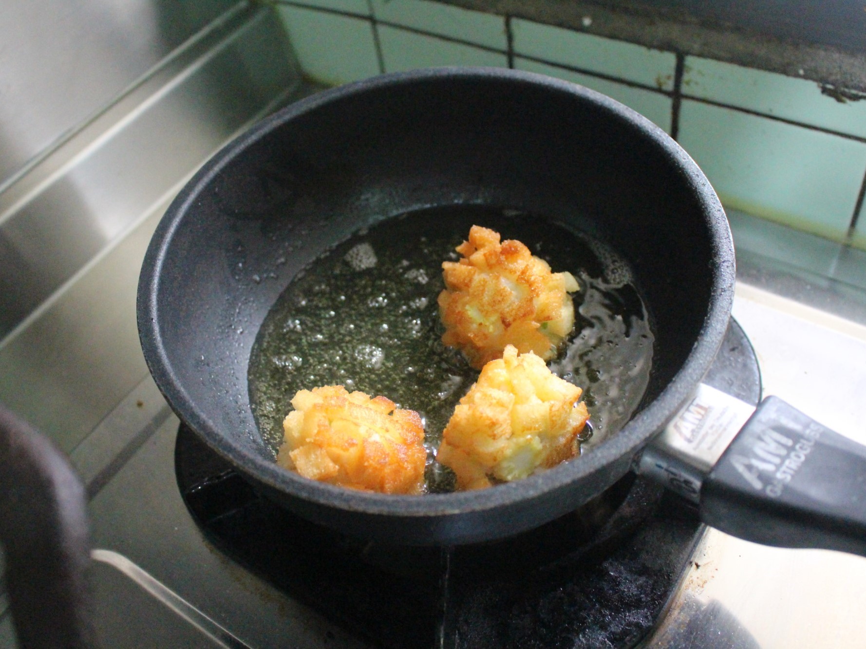 將玉米筍蝦球煎至焦金色，就可以撈出來上桌。